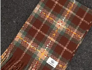 Close-up showing the soft texture and brown plaid pattern of this warm winter scarf
