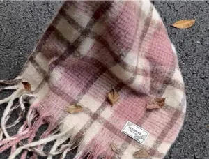 Detail view of soft pink mohair plaid scarf with fringe and aesthetic label