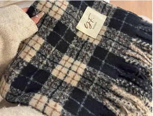 Close-up detail of retro plaid scarf showing fabric texture and G.F. BLOSSOM brand tag.