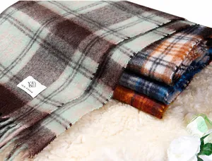 Detail shot of thick Maillard plaid scarves with mohair-like texture and soft fringe