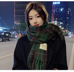 Retro green plaid winter scarf with tassels for women worn by a model in city night