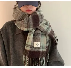 Close-up of thick plaid mohair scarf with soft texture and decorative brand label