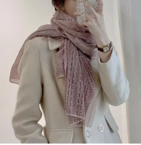 Detailed close-up of a dusty rose linen cotton scarf featuring elegant lace stitching.