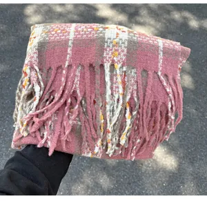 Detailed close-up view of a pink plaid scarf showing soft cashmere-like texture