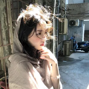 Retro solid color cotton linen pleated scarf worn by a female model in sunlight