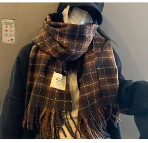 Close-up of retro brown plaid tassel scarf worn by a model in winter style