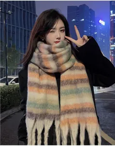 Soft mohair plaid scarf with tassels worn by a model in an urban night setting.
