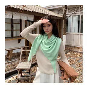 Soft mint green knit triangular shawl for women styled with a casual autumn outfit