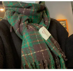 Close-up of green check vintage scarf showing soft cashmere-like texture and tassels