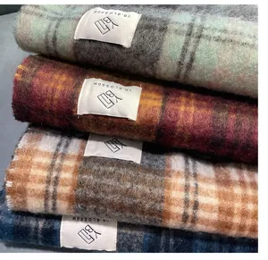Macro view of thick Maillard plaid scarves showing soft mohair texture and colors