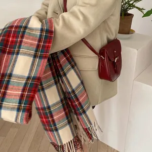 Stylish checkered faux cashmere scarf in warm beige and red tones, perfect for winter layering.