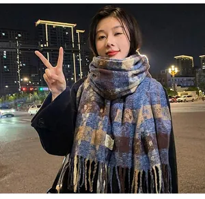 Warm woven plaid scarf in blue and brown hues styled on a model in a winter street scene