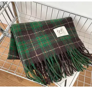 Detailed view of a soft retro green plaid winter scarf with tassels in a wire cart