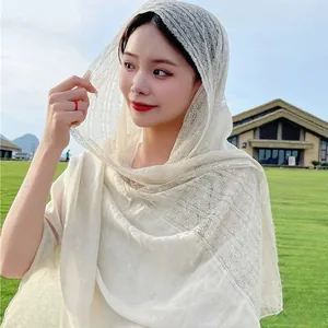Elegant linen-colored spliced lace cotton linen scarf for women in a soft outdoor setting