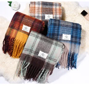 Detailed view of colorful Maillard plaid mohair-like scarves with soft tassel fringe.