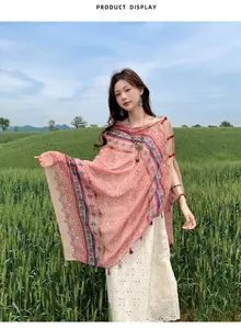 Ethnic style pink sun protection shawl with frog buttons worn in a scenic field