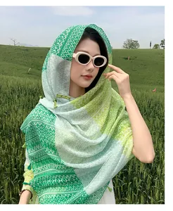Ethnic style hooded sun protection shawl with traditional frog buttons on a model