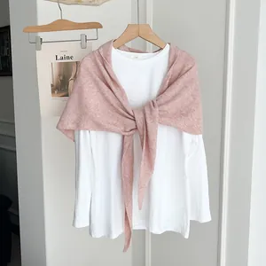 Soft elegant solid pink knitted shawl scarf paired with white long-sleeved shirt