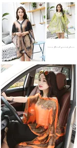 Detailed views of sheer paisley print sun protection shawls with pearl buckle accents