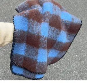Close-up detail of blue and brown checkered mohair scarf showing soft fuzzy textile texture