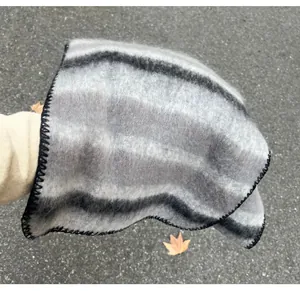 Detailed view of cozy fuzzy mohair striped winter scarf with blanket stitch edges