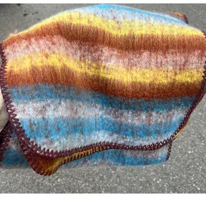 Close-up of mohair scarf texture with blanket stitched edges and colorful stripes.