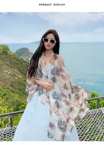 Asian model wearing a long tiger print Bali yarn sun protection shawl at the beach