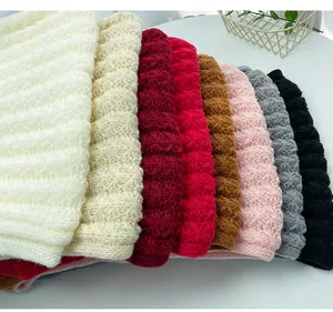 Close-up of vibrant winter knitted scarves in various colors showing soft textured ribbing