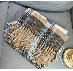 Cozy brown and blue plaid cashmere-like scarf with thick tassels for winter warmth.