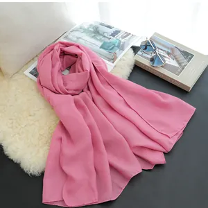 Detail shot of a soft pink cotton linen scarf with elegant fabric texture