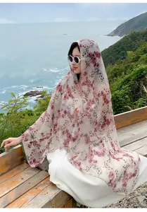 Detail showing the floral print and fabric of the beach shawl on a female model
