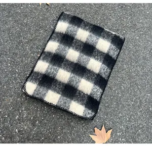 Close-up of a soft mohair checkered scarf in black and white plaid pattern for winter