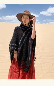 Bohemian ethnic knit poncho with colorful patterns and tassels for winter travel