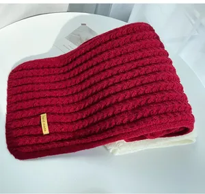 Close-up of thick red knitted scarf with handmade tag for winter season