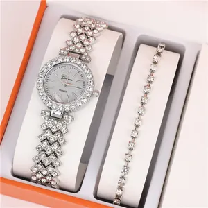 Close-up detail of silver rhinestone watch and bracelet set in an orange gift box