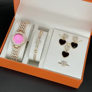 Detailed view of elegant women's watch and heart jewelry set in orange gift box.