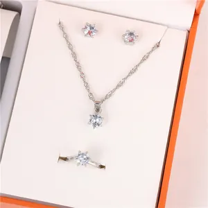 Elegant silver-tone jewelry set featuring necklace, earrings, and ring in premium orange gift box