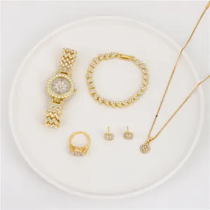 Detail view of a 5-piece elegant gold-tone jewelry set with shimmering rhinestone accents.