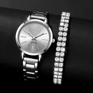 Detailweergave van een zilveren dameshorloge met een sprankelende strass-armband set.