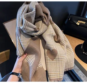 Detail view of heart pattern and plaid texture on soft winter cashmere-like scarf