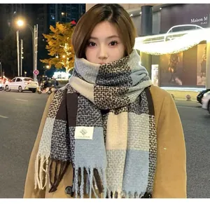 Close-up of soft plaid mohair scarf texture and fringes worn by a model in night street.