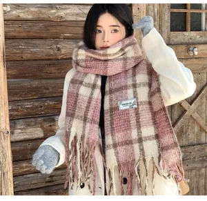 Close-up of mohair plaid scarf with fringes on Asian model in winter cabin scene