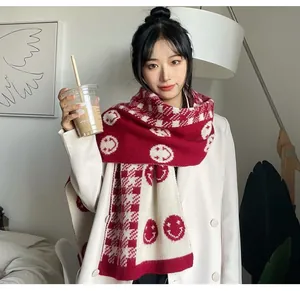 Asian model wearing red and white knitted scarf with smiley face and checkered patterns