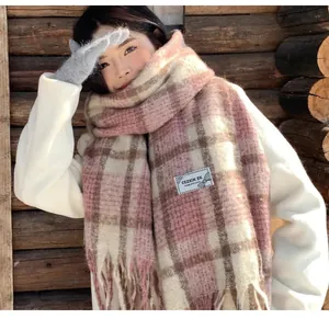 Soft and cozy pink mohair plaid scarf featuring stylish fringes and a small woven label