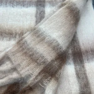 Soft mohair plaid scarf with warm beige and brown check pattern texture macro view