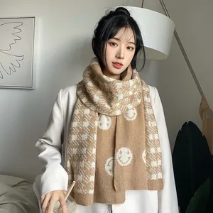 Elegant brown and white checkered knitted scarf featuring charming white smiley faces