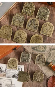 Vintage brass paper clips featuring intricate engraved garden designs.