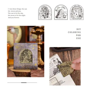 Detail view of vintage metal stationery clips with intricate butterfly and rose engravings