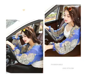 Close-up of elegant paisley print chiffon sun protection shawl worn during car driving