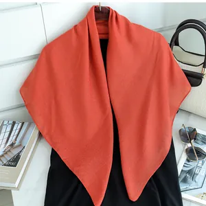 Solid orange-red cotton linen square scarf for women, elegant lifestyle detail view.